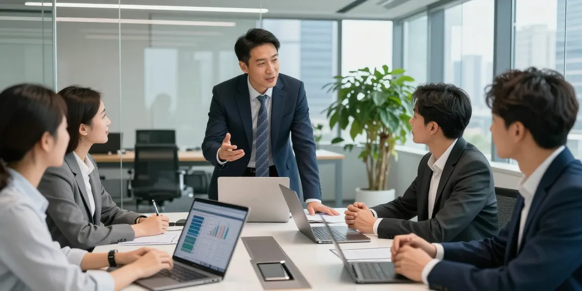 Terry Hui leading an engaging team discussion in a modern office.